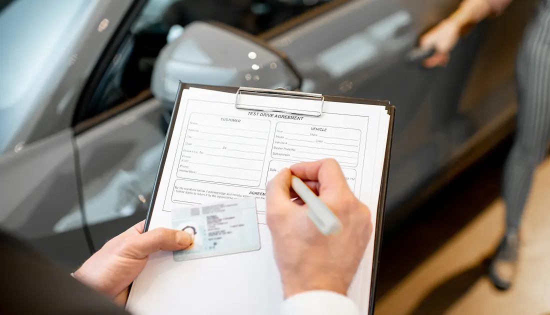 Person signing car rental form