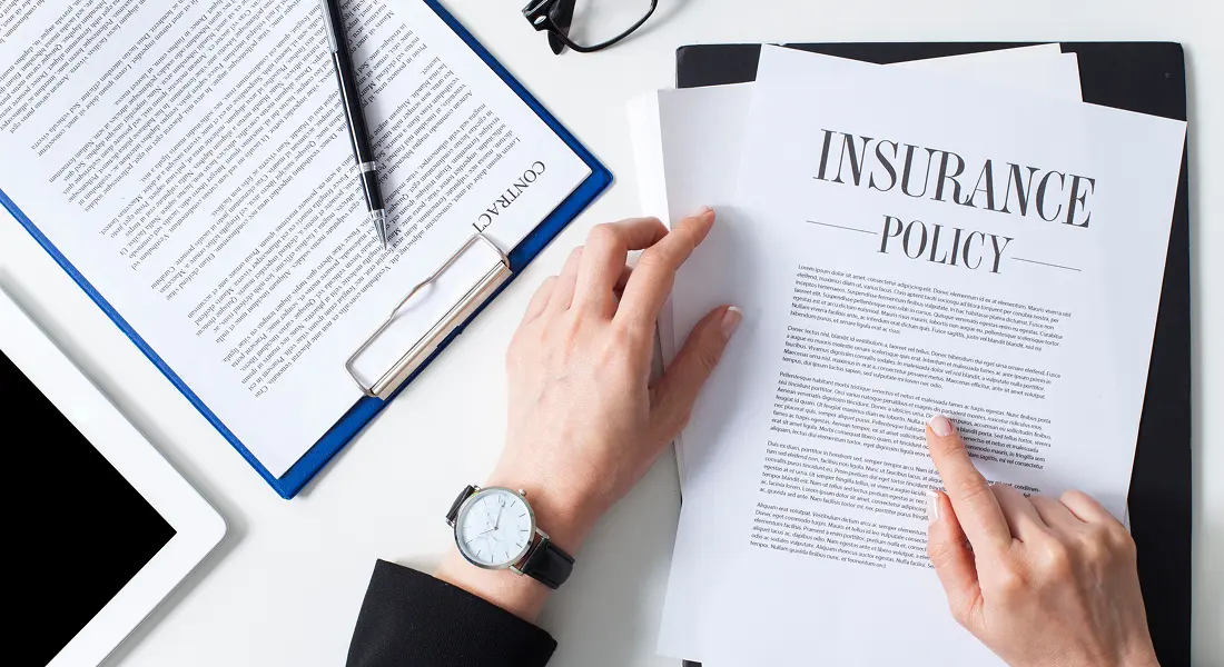 Person pointing at insurance policy text