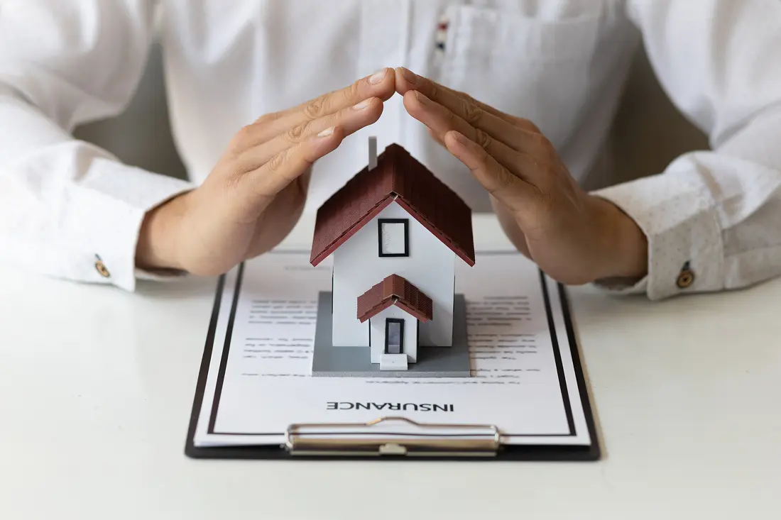 Protecting house with hands over policy
