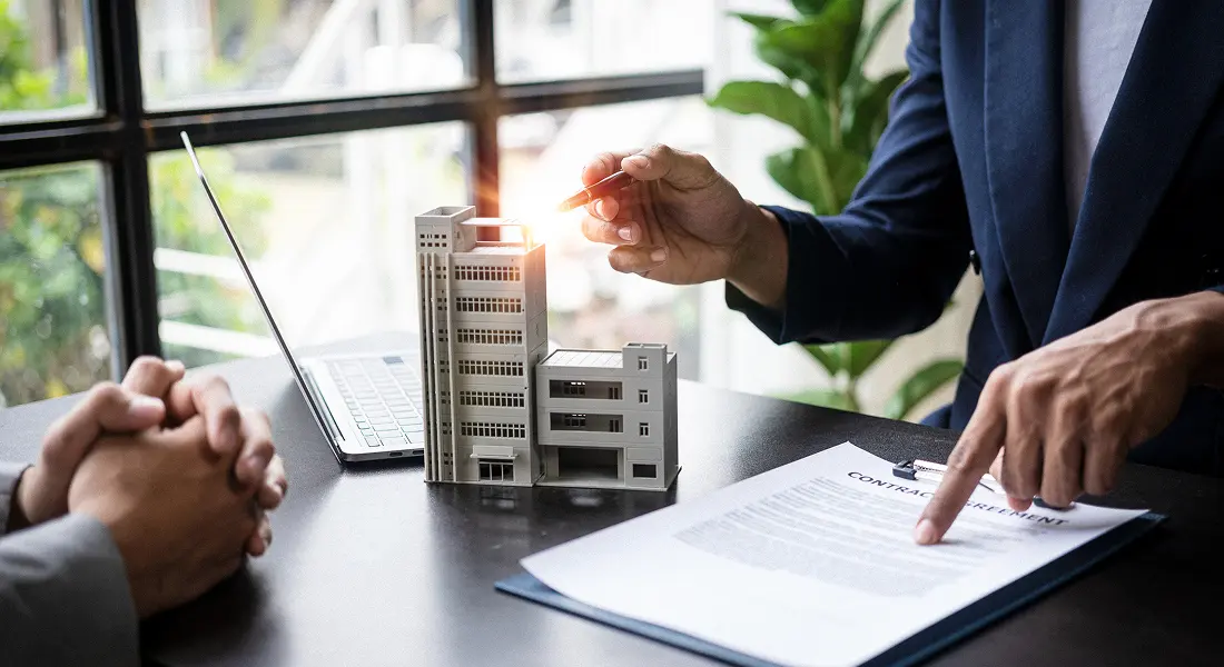 Professionals reviewing property agreement document