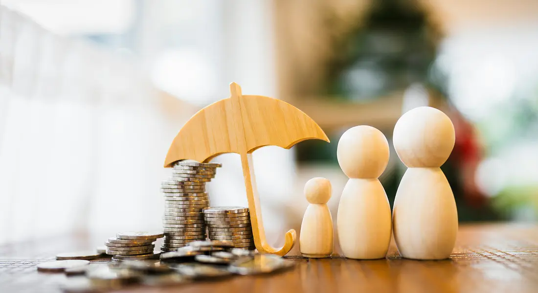 Coin stacks sheltered by umbrella and figures