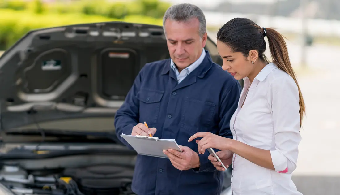 Mechanic and woman discussing car repair