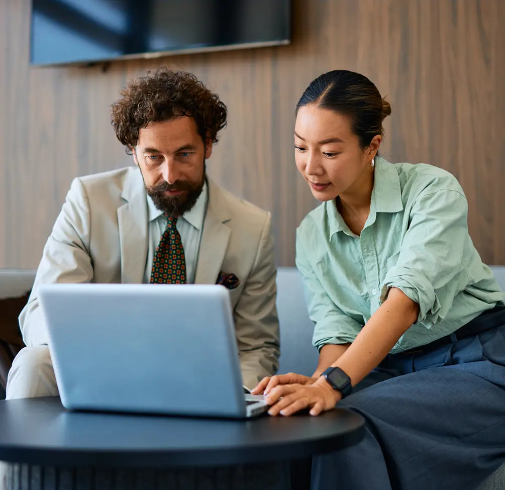 Two colleagues working on a laptop