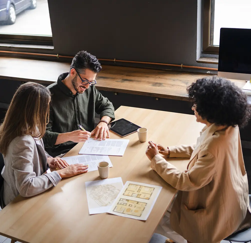 Professionals reviewing blueprints in office setting