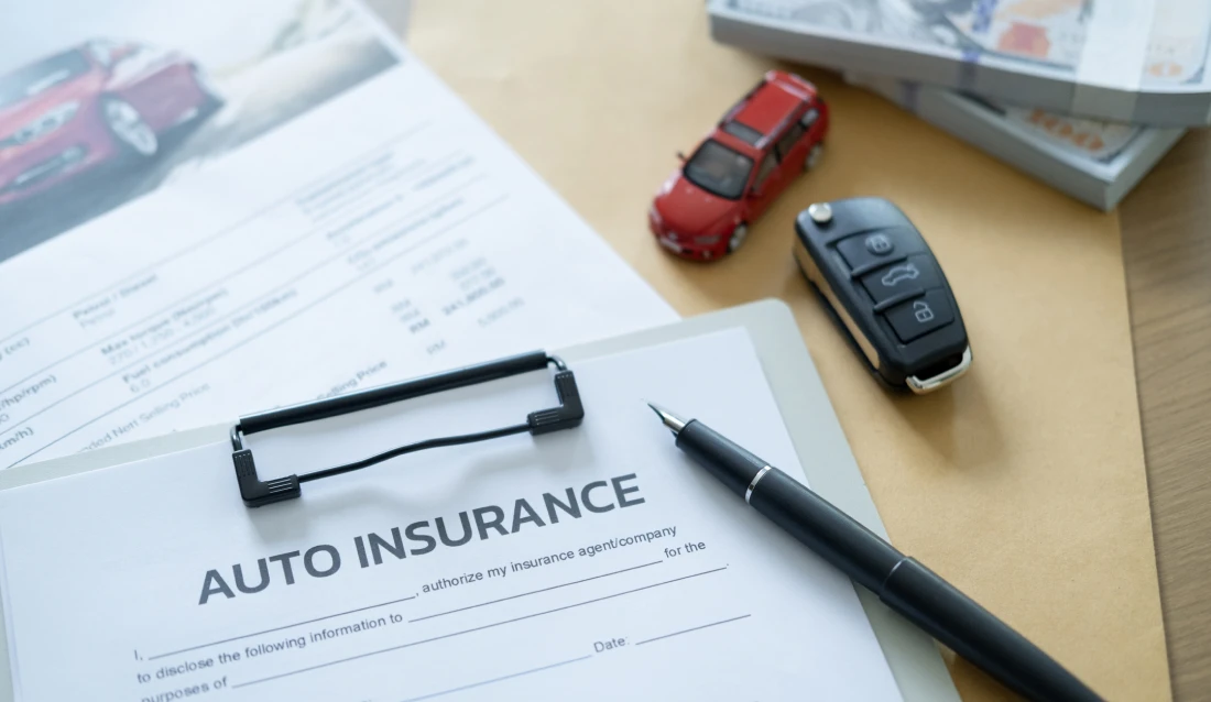 Car insurance document and toy car