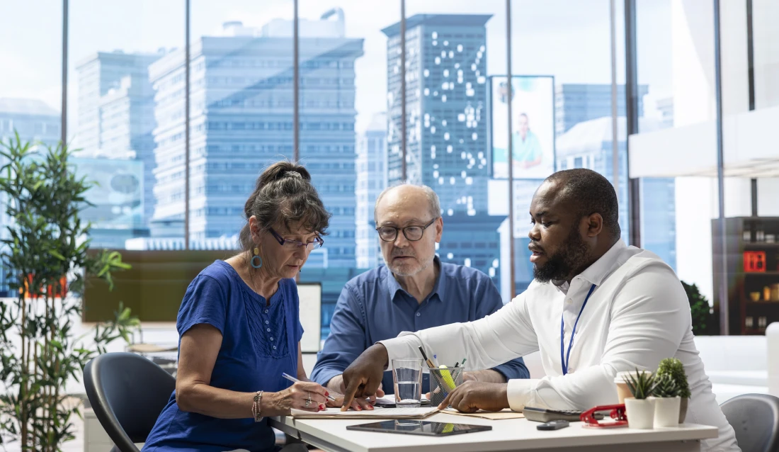 Team discussing work documents indoors